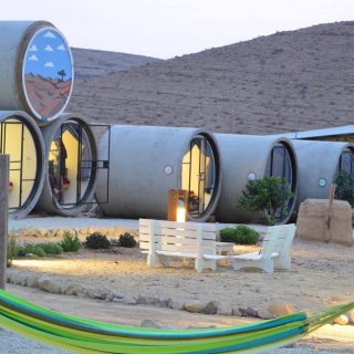 Sleep in concrete capsules in the heart of the desert